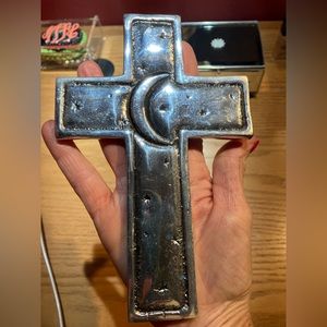 Metal cross with moon and stars.